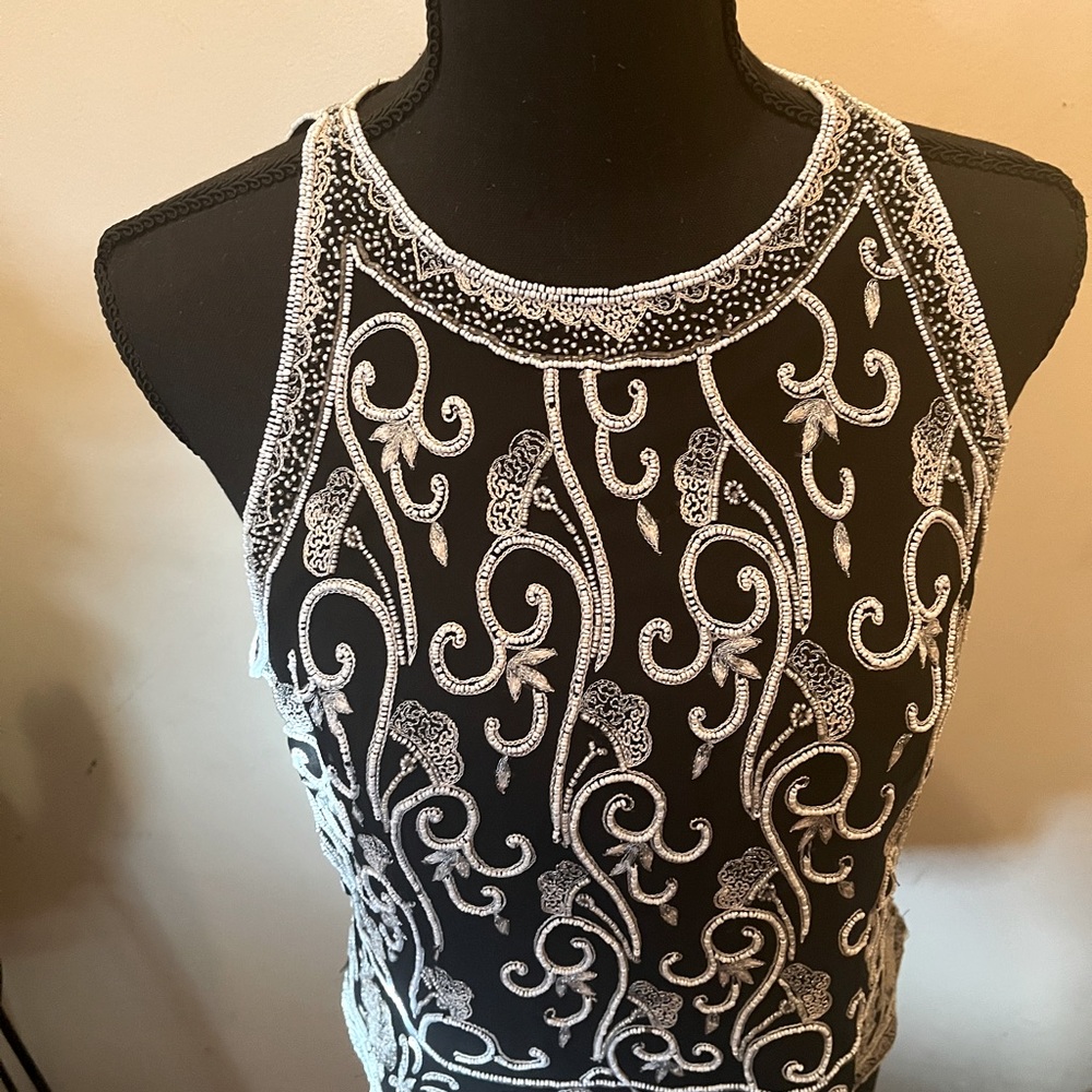 Embroidery design with tiny white/silver beads with 18” zipper. Loose fitting.
